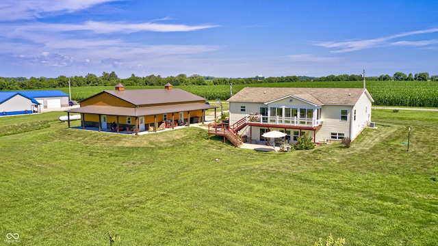 4297 W Division Rd, Crawfordsville, IN 47933 - rear view of property featuring a lawn, a patio, and a view of countryside