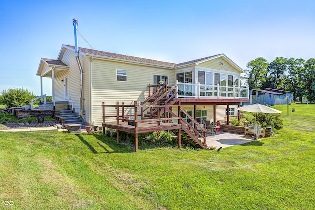 4297 W Division Rd, Crawfordsville, IN 47933 - back of house with stairs, a patio, a sunroom, a wooden deck, and a yard