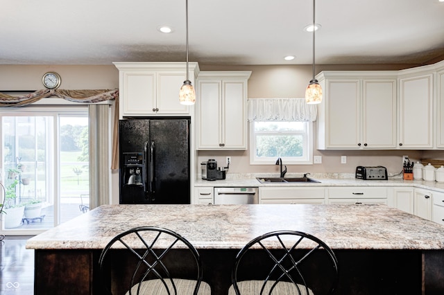 4297 W Division Rd, Crawfordsville, IN 47933 - kitchen with black fridge with ice dispenser, stainless steel dishwasher, healthy amount of natural light, hanging light fixtures, and recessed lighting