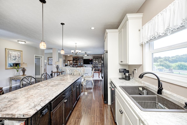 4297 W Division Rd, Crawfordsville, IN 47933 - kitchen with a center island, light countertops, dishwasher, white cabinets, and hanging light fixtures