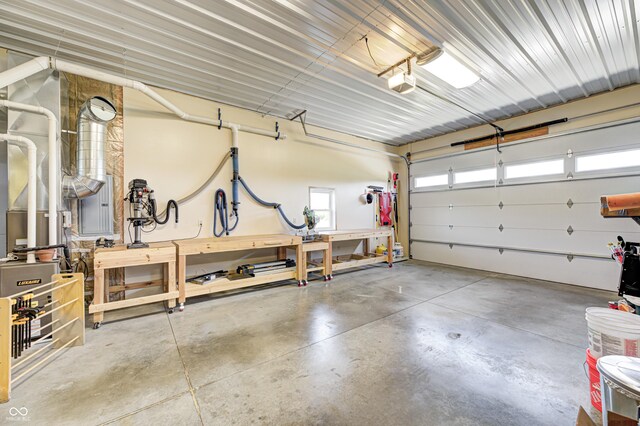 4297 W Division Rd, Crawfordsville, IN 47933 - garage with a workshop area and a garage door opener