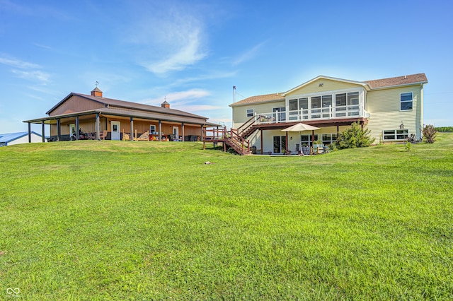 4297 W Division Rd, Crawfordsville, IN 47933 - back of house featuring a sunroom, a yard, stairway, and a wooden deck