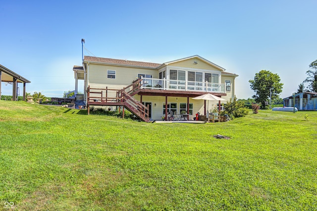 4297 W Division Rd, Crawfordsville, IN 47933 - rear view of house featuring a sunroom, stairway, a wooden deck, a lawn, and a patio