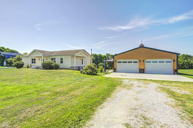 4297 W Division Rd, Crawfordsville, IN 47933 - ranch-style house featuring a detached garage, driveway, a front lawn, an outdoor structure, and board and batten siding
