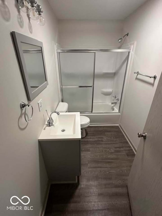 95 Rural St, Austin, IN 47102 - full bath featuring vanity, wood finished floors, and bath / shower combo with glass door