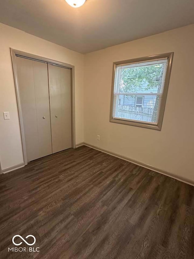 95 Rural St, Austin, IN 47102 - unfurnished bedroom featuring dark wood finished floors and a closet