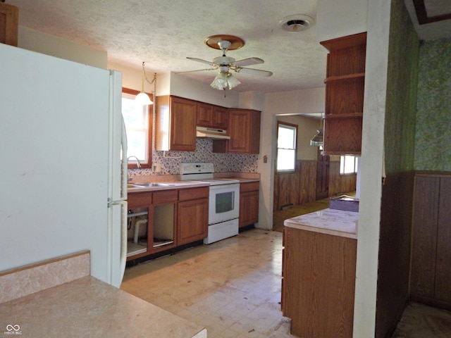 3926 S County Road 550 W, Coatesville, IN 46121 - kitchen featuring white appliances, light floors, under cabinet range hood, open shelves, and brown cabinetry