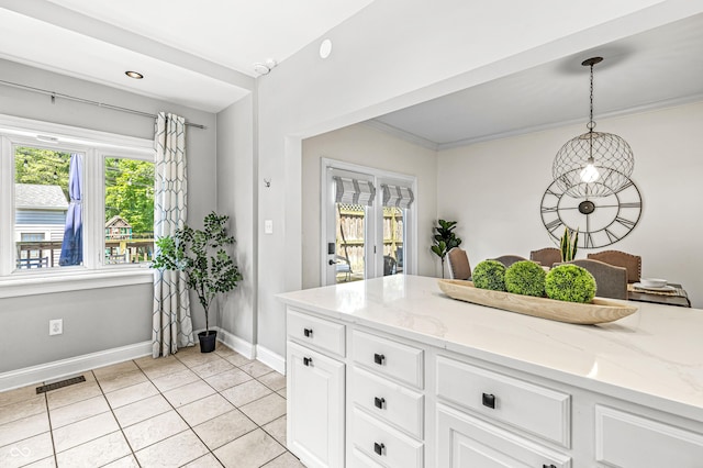 4920 Central Ave, Indianapolis, IN 46205 - kitchen with light tile patterned flooring, decorative light fixtures, light stone counters, white cabinetry, and ornamental molding