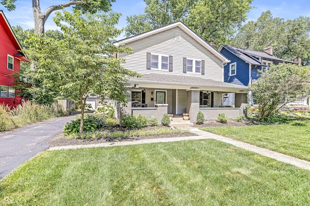 4920 Central Ave, Indianapolis, IN 46205 - view of front of home featuring a porch, a front lawn, and brick siding