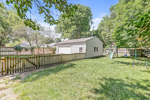 4920 Central Ave, Indianapolis, IN 46205 - fenced backyard featuring a garage, a playground, and an outdoor structure