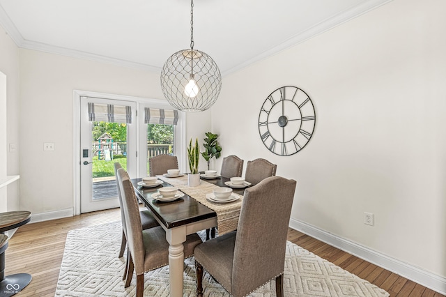 4920 Central Ave, Indianapolis, IN 46205 - dining area featuring ornamental molding, a chandelier, and light wood-type flooring