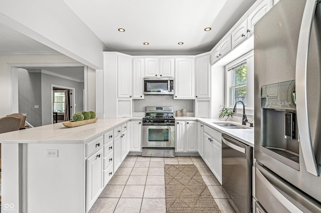 4920 Central Ave, Indianapolis, IN 46205 - kitchen with stainless steel appliances, a peninsula, light tile patterned floors, recessed lighting, and white cabinets