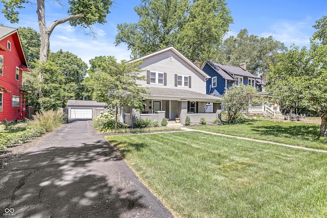 4920 Central Ave, Indianapolis, IN 46205 - view of front of property with a porch, a detached garage, an outdoor structure, and a front lawn