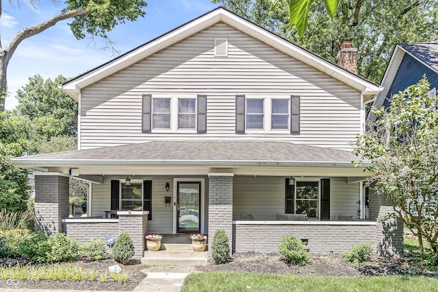 4920 Central Ave, Indianapolis, IN 46205 - view of front of home with covered porch, a chimney, brick siding, and a shingled roof