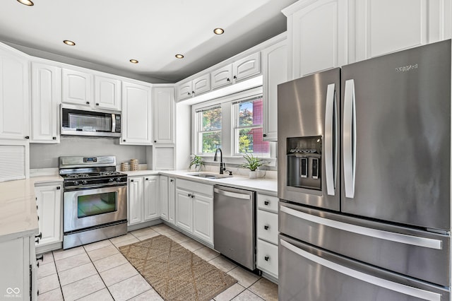 4920 Central Ave, Indianapolis, IN 46205 - kitchen featuring appliances with stainless steel finishes, recessed lighting, light tile patterned floors, white cabinets, and light countertops