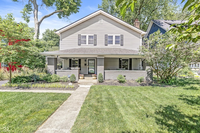 4920 Central Ave, Indianapolis, IN 46205 - view of front of house with brick siding, a front yard, covered porch, and a chimney