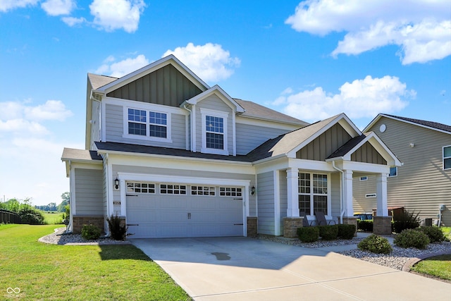 13525 Forest Glade Dr, Fishers, IN 46037 - craftsman-style home featuring board and batten siding, a front lawn, driveway, and stone siding