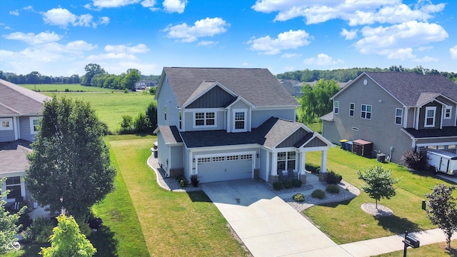 13525 Forest Glade Dr, Fishers, IN 46037 - view of front facade with concrete driveway, roof with shingles, board and batten siding, a front lawn, and an attached garage