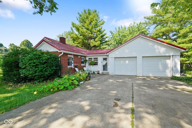 4 Kentwood Dr, Greencastle, IN 46135 - single story home with a chimney, a garage, concrete driveway, a metal roof, and brick siding