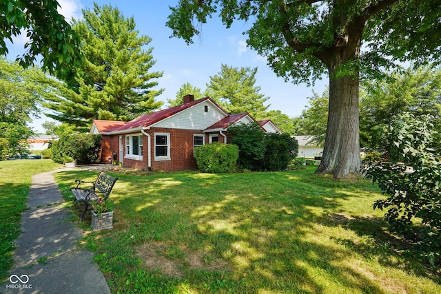 4 Kentwood Dr, Greencastle, IN 46135 - view of front of property with a front yard, a chimney, and brick siding