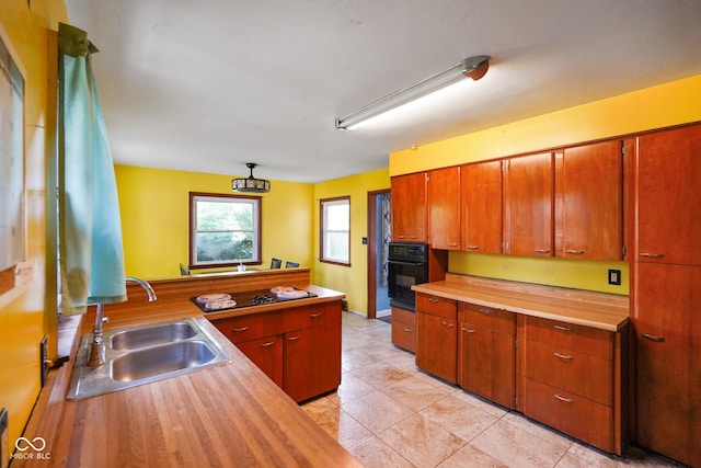 4 Kentwood Dr, Greencastle, IN 46135 - kitchen featuring black oven, wooden counters, a peninsula, and brown cabinetry