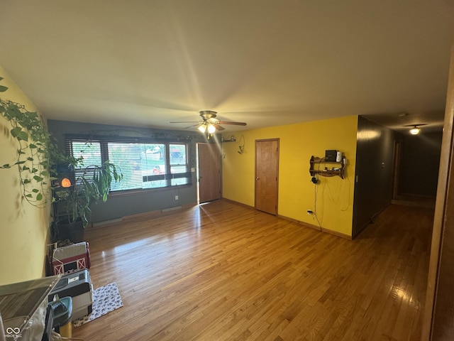 8394 E Mulberry St, Columbus, IN 47203 - unfurnished living room featuring wood finished floors and a ceiling fan