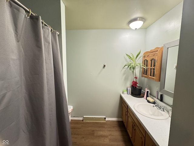 8394 E Mulberry St, Columbus, IN 47203 - full bath with wood finished floors, vanity, and curtained shower