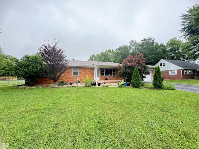 8394 E Mulberry St, Columbus, IN 47203 - single story home featuring a front yard, brick siding, and asphalt driveway