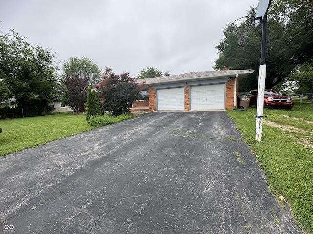 8394 E Mulberry St, Columbus, IN 47203 - view of front of home featuring a front lawn, a garage, driveway, and brick siding