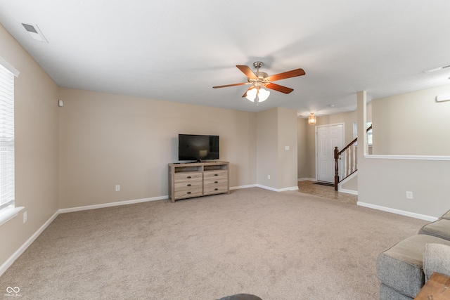 546 Greenwood Trace Dr, Whiteland, IN 46184 - unfurnished living room with a ceiling fan, light carpet, and healthy amount of natural light