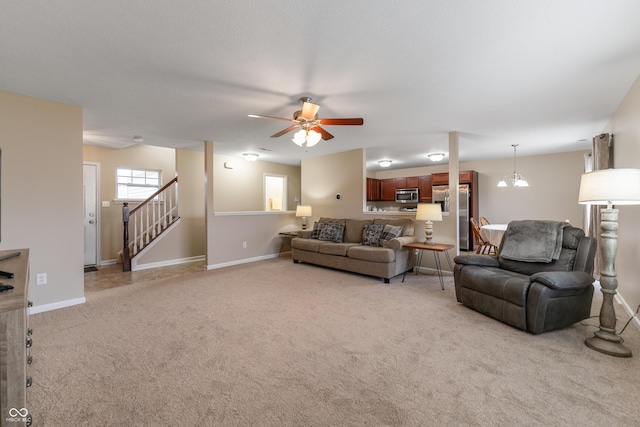 546 Greenwood Trace Dr, Whiteland, IN 46184 - living area with light carpet, a ceiling fan, stairs, and a chandelier