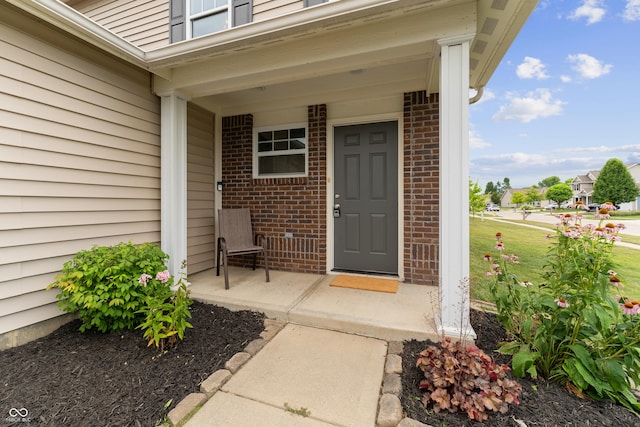 546 Greenwood Trace Dr, Whiteland, IN 46184 - view of exterior entry featuring brick siding and a porch