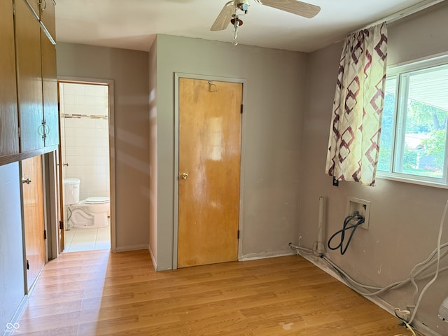 2212 Hanover Dr, Indianapolis, IN 46227 - unfurnished bedroom featuring light wood finished floors, ensuite bathroom, and ceiling fan