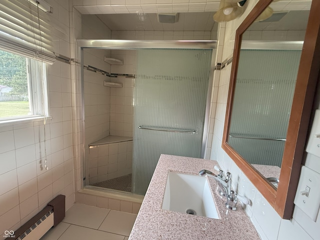 2212 Hanover Dr, Indianapolis, IN 46227 - full bathroom with a baseboard heating unit, a stall shower, vanity, and tile walls