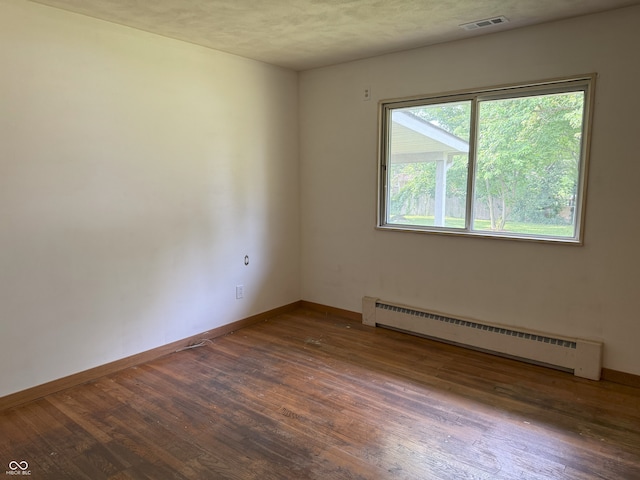 2212 Hanover Dr, Indianapolis, IN 46227 - empty room featuring baseboard heating and wood finished floors