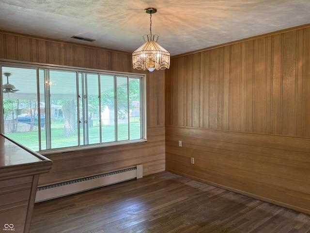 2212 Hanover Dr, Indianapolis, IN 46227 - spare room featuring baseboard heating, a chandelier, wood walls, and dark wood-style flooring