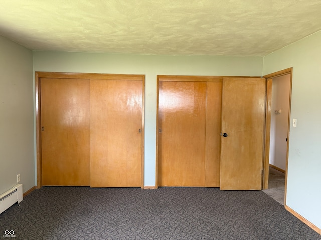 2212 Hanover Dr, Indianapolis, IN 46227 - unfurnished bedroom with baseboard heating, multiple closets, and carpet flooring