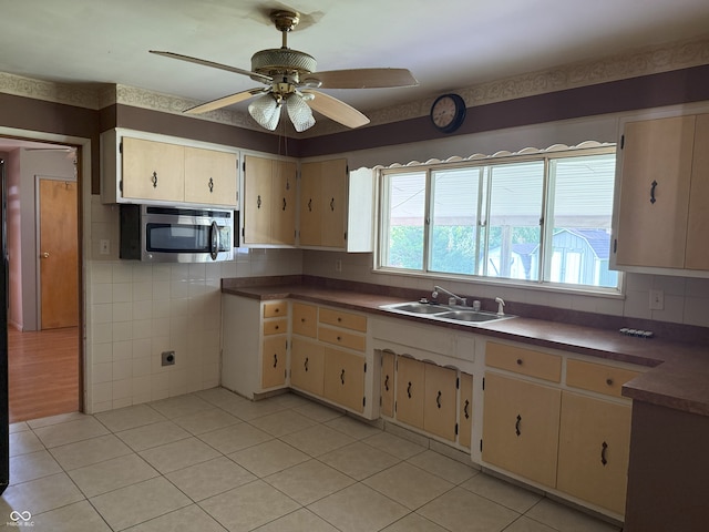 2212 Hanover Dr, Indianapolis, IN 46227 - kitchen featuring stainless steel microwave, light tile patterned floors, a ceiling fan, and dark countertops