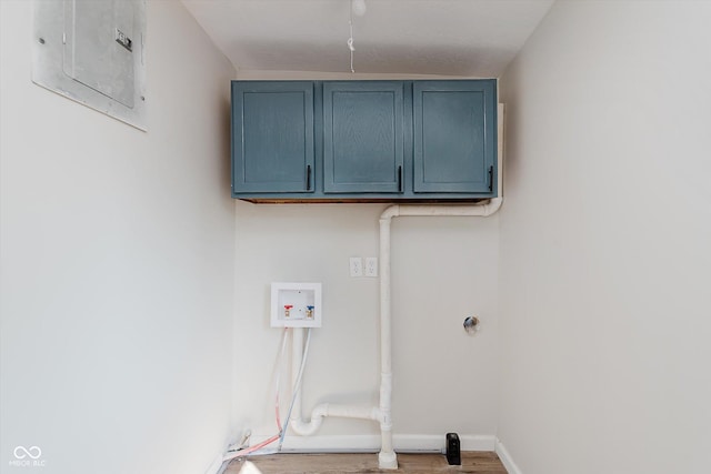 312 E Columbia St, Attica, IN 47918 - washroom with electric panel, cabinet space, washer hookup, and wood finished floors