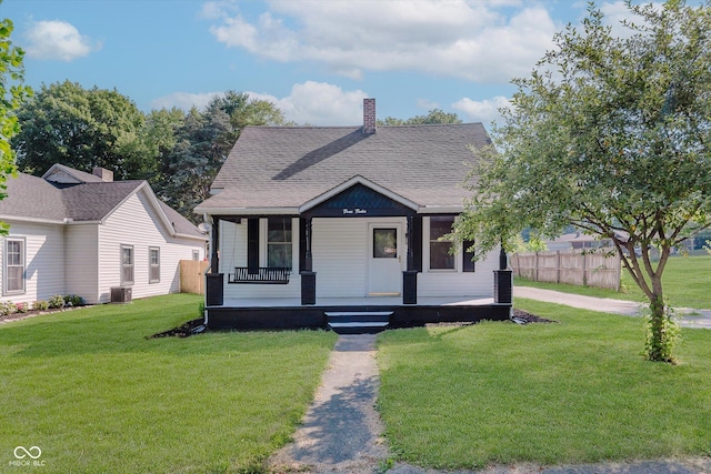 312 E Columbia St, Attica, IN 47918 - bungalow-style house featuring covered porch, a chimney, and roof with shingles
