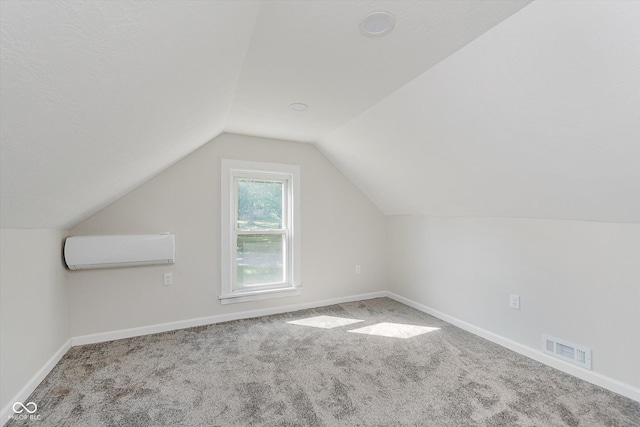 312 E Columbia St, Attica, IN 47918 - bonus room with a wall mounted air conditioner, carpet floors, and vaulted ceiling