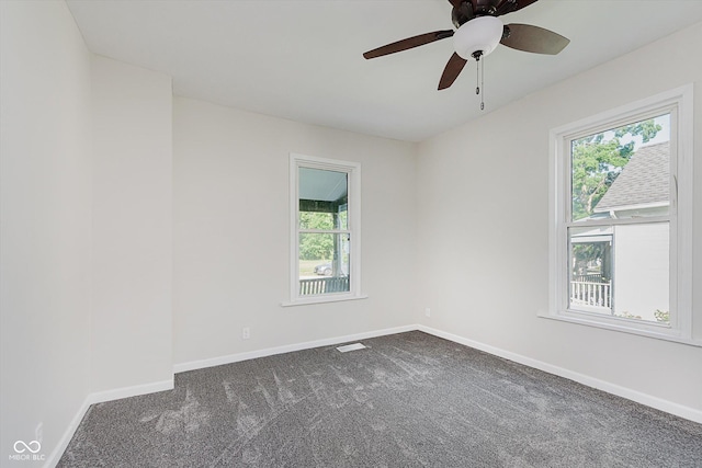 312 E Columbia St, Attica, IN 47918 - empty room with healthy amount of natural light, dark colored carpet, and ceiling fan