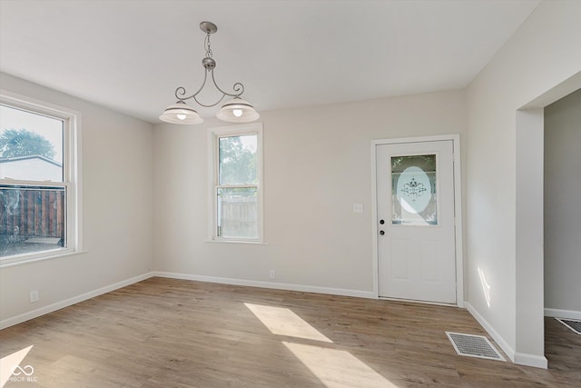 312 E Columbia St, Attica, IN 47918 - entryway featuring plenty of natural light, wood finished floors, and a chandelier