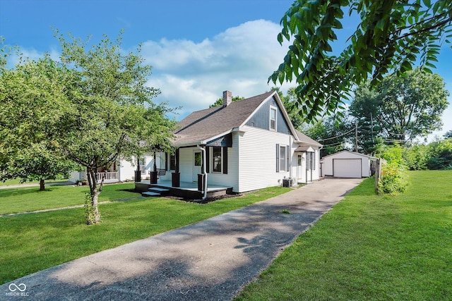 312 E Columbia St, Attica, IN 47918 - view of front of property featuring driveway, an outbuilding, a porch, a detached garage, and a front lawn
