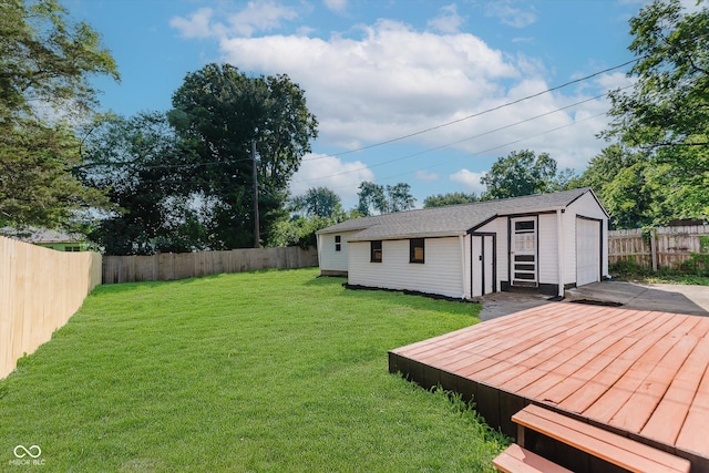 312 E Columbia St, Attica, IN 47918 - fenced backyard with a deck, an outdoor structure, and a detached garage
