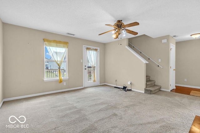 5971 Portman Pl, Plainfield, IN 46168 - unfurnished living room featuring ceiling fan, carpet flooring, stairway, and a textured ceiling