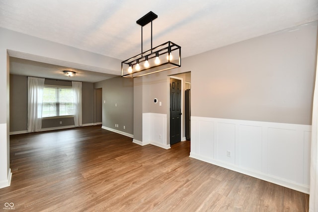 3675 Homestead Cir E, Plainfield, IN 46168 - spare room featuring wood finished floors, a chandelier, and wainscoting