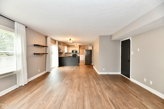 3675 Homestead Cir E, Plainfield, IN 46168 - unfurnished living room featuring wood finished floors and baseboards