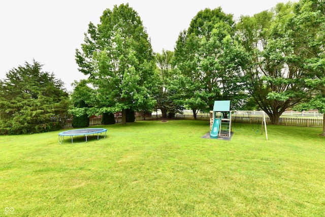 3675 Homestead Cir E, Plainfield, IN 46168 - fenced backyard featuring a trampoline and a playground