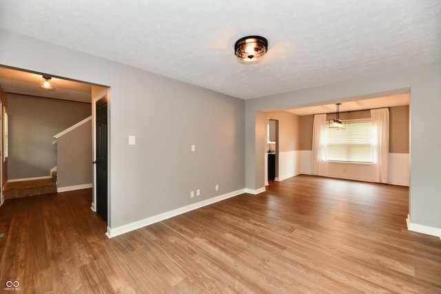 3675 Homestead Cir E, Plainfield, IN 46168 - unfurnished room with wood finished floors, stairs, and a textured ceiling